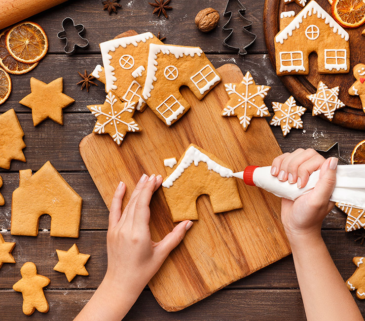 Person decorating holiday cookies at Oceana Coastal Kitchen at the Catamaran