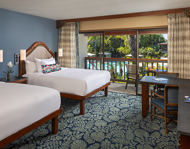  Interior poolside room on the second floor with two queen beds at the Catamaran Resort Hotel and Spa looking out to the pool.
